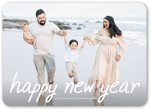 Happy new year card with white font and family posing at the beach